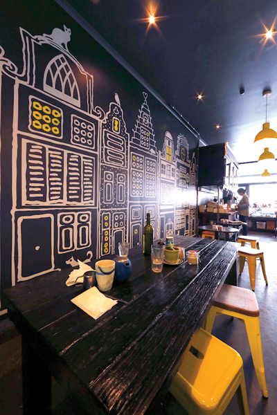 Graphic art adorns the walls of Torch cafe in Melbourne, designed by Henrietta Reed. Photo by Bruce Lindsay
