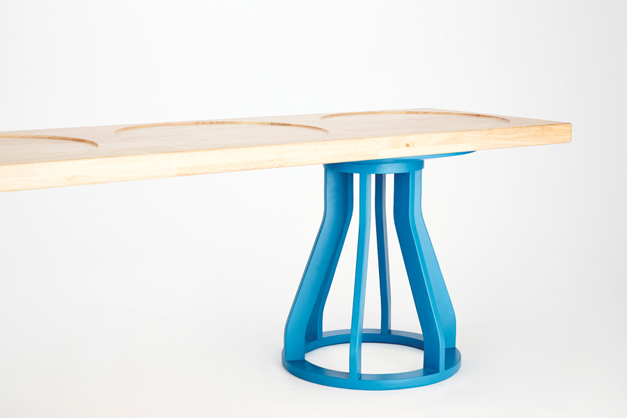 An extension of the Spool stool, Goulder’s Plank bench features a solid rubberwood bench atop two stools