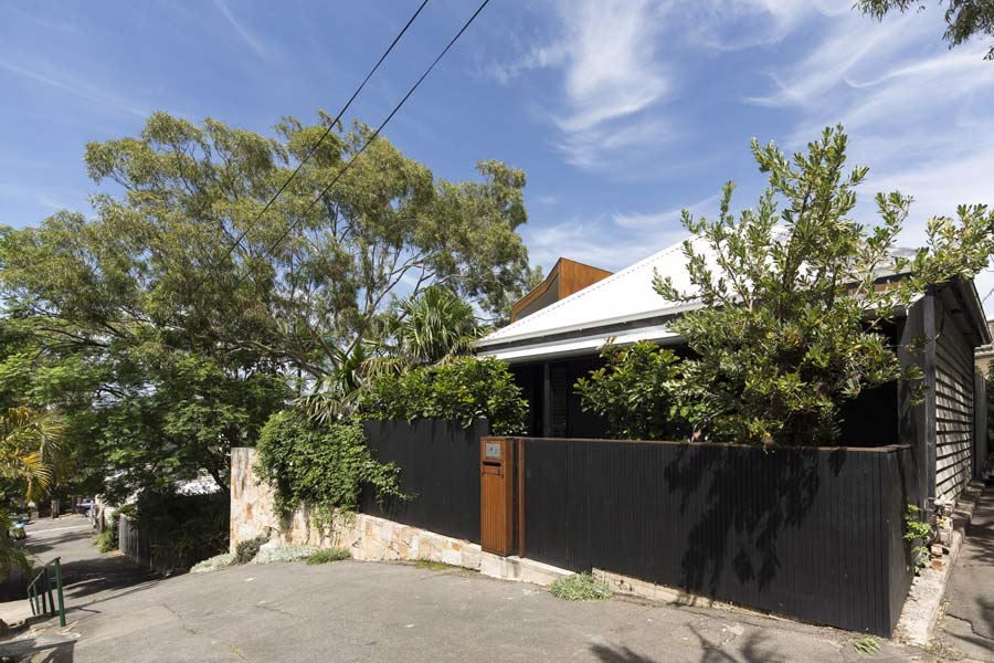 House nestles within a suburban context