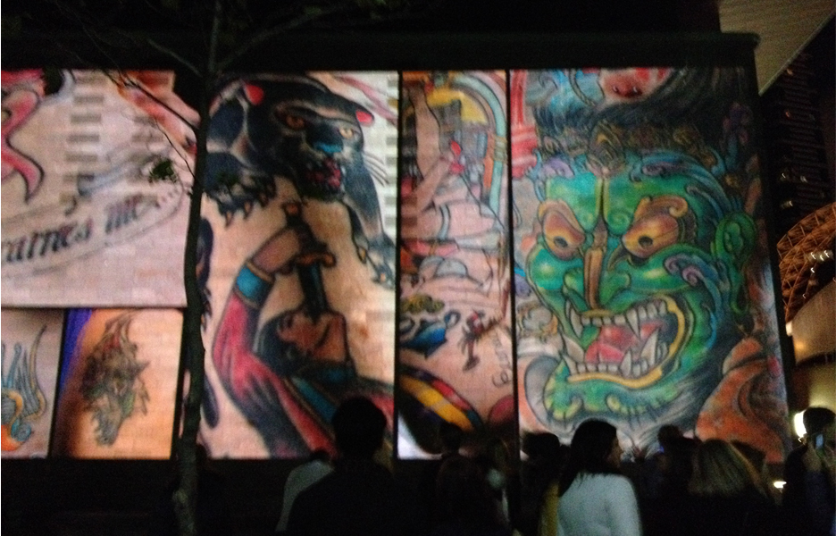 A collage of tattoo art projected on the facade of the National Gallery of Victoria