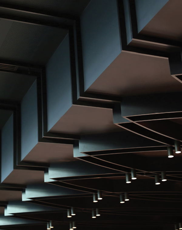 Ceiling detail incorporates lighting that has been positioned to accentuate the white tablecloths and add drama.