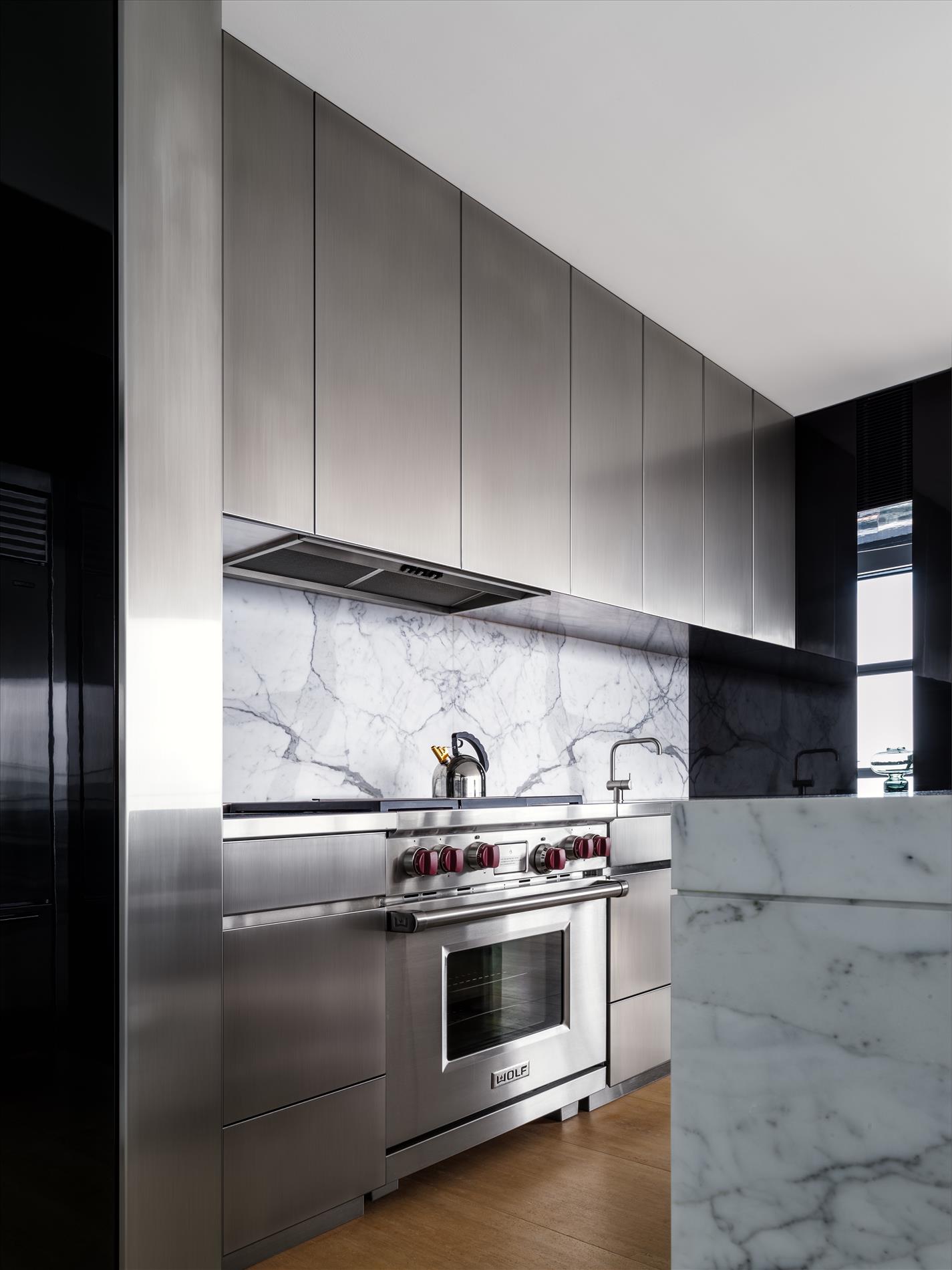 Calacatta marble and reflective surfaces round out the material palette.