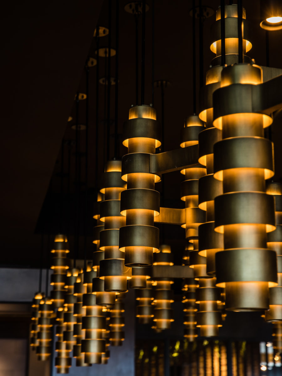 The custom light feature has mid century influences. Photo by Nikki To. 