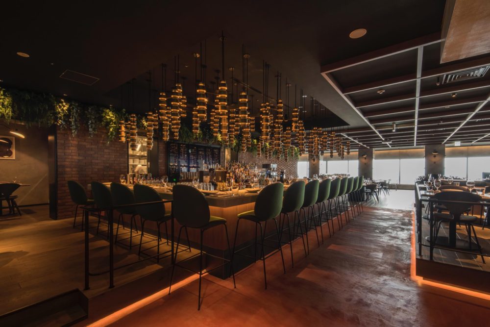 Hanging over the bar sits a bespoke light feature. Photo by Satoshi Matsuo.