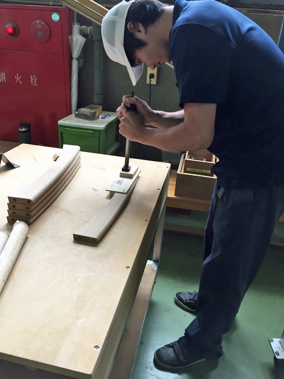 A local craftsman working on a piece of timber at the Nissin factory in Hida, Japan.