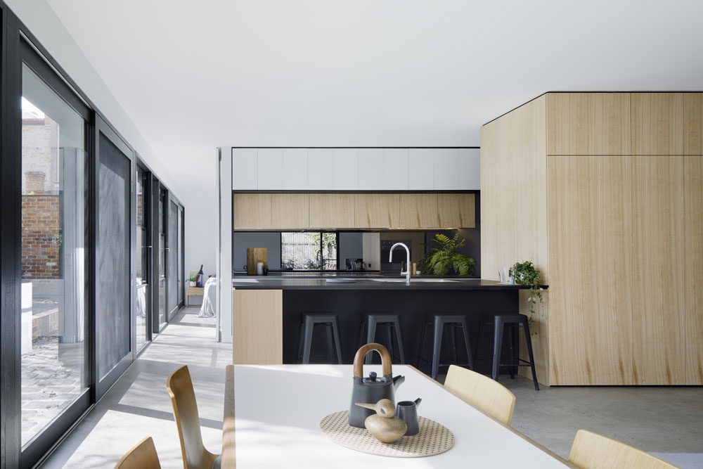 The open place kitchen space with a pivot door connecting the bedroom.