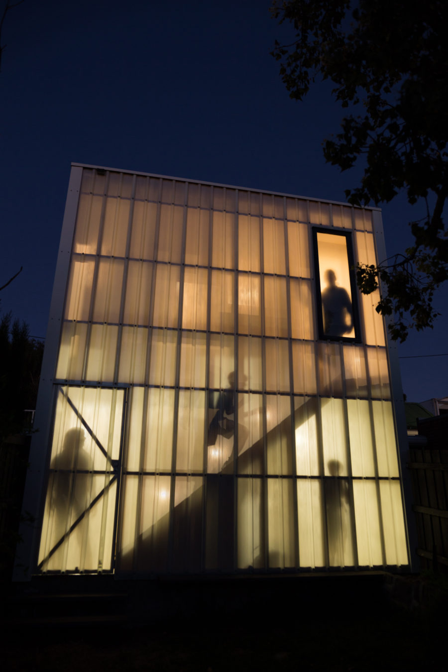 Silhouettes can be seen using the stairwell in the Studio Garage by Krisna Cheung Architects. Photo by Wei Wei.