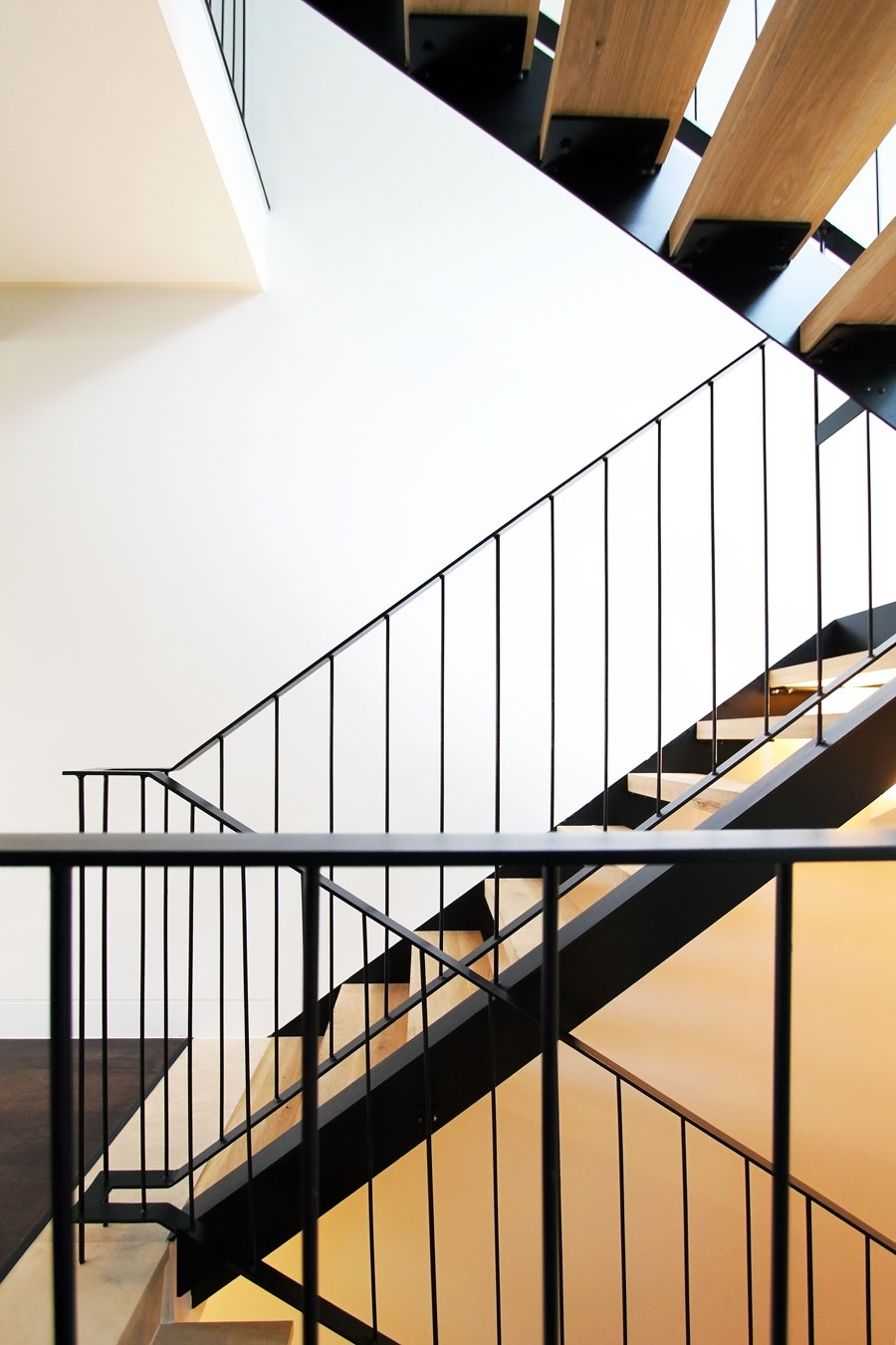 House A: a sleek open rise timber stair.