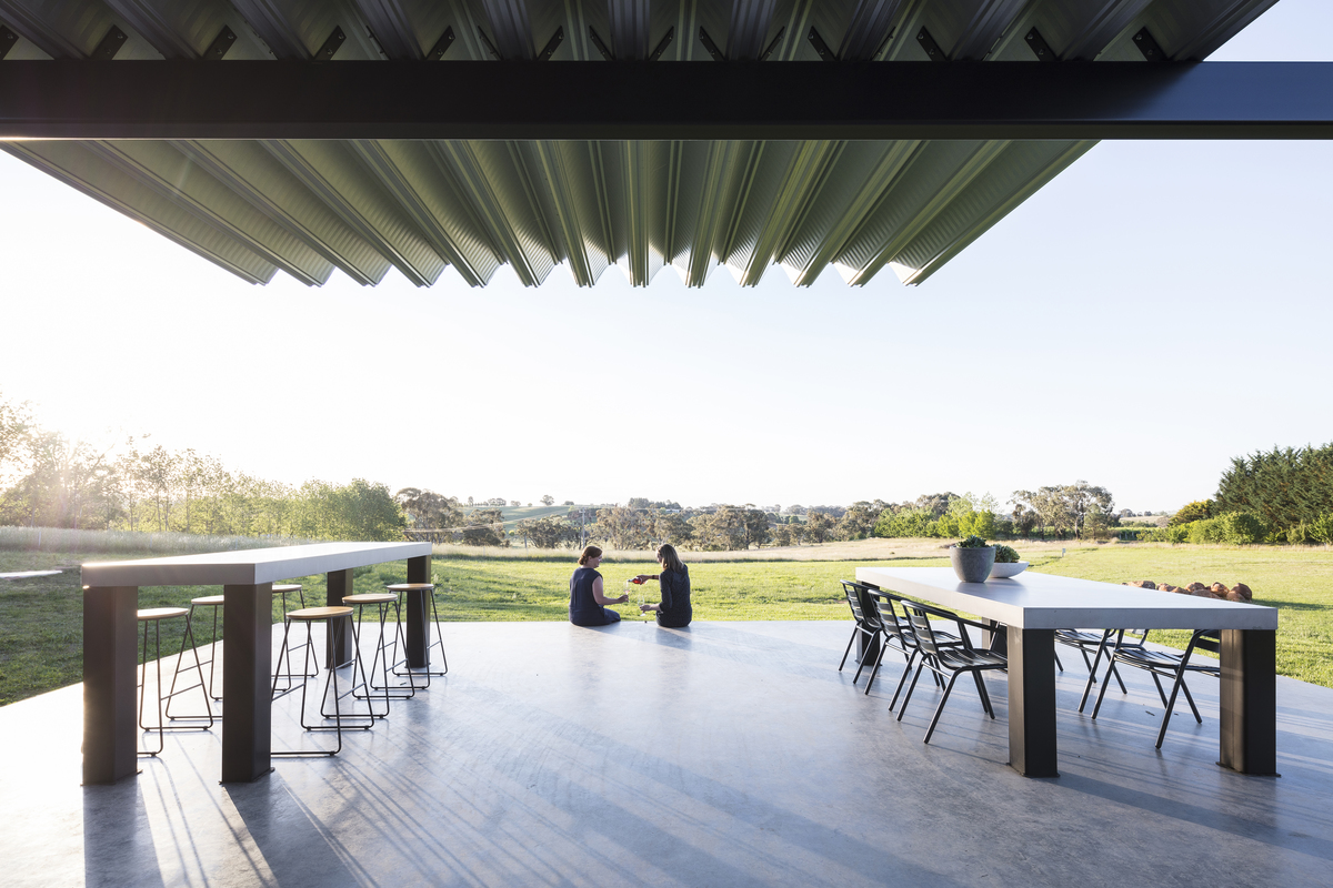 Visitors spending a lazy sunday afternoon tasting on the edge of the verandah watching the sun go down