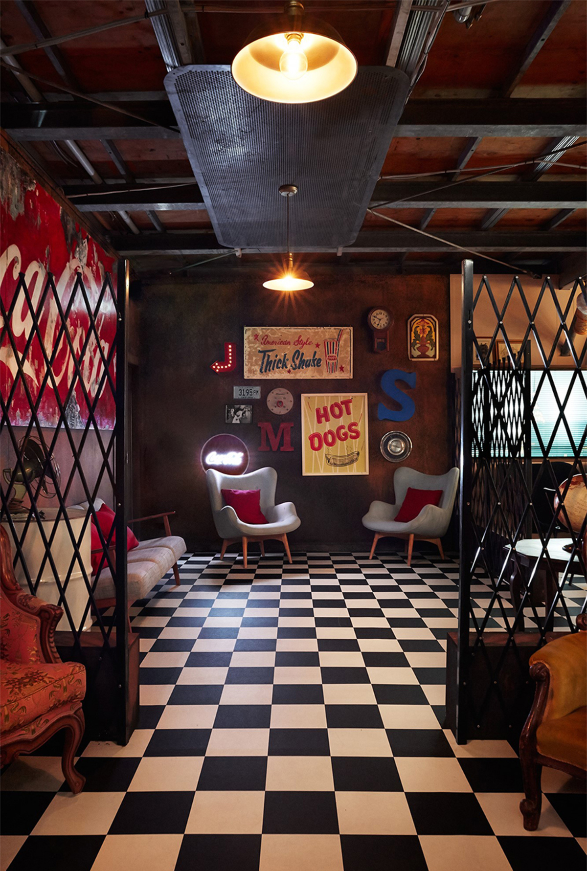 the black and white checker floor past the retro bar and through the rusty gates,