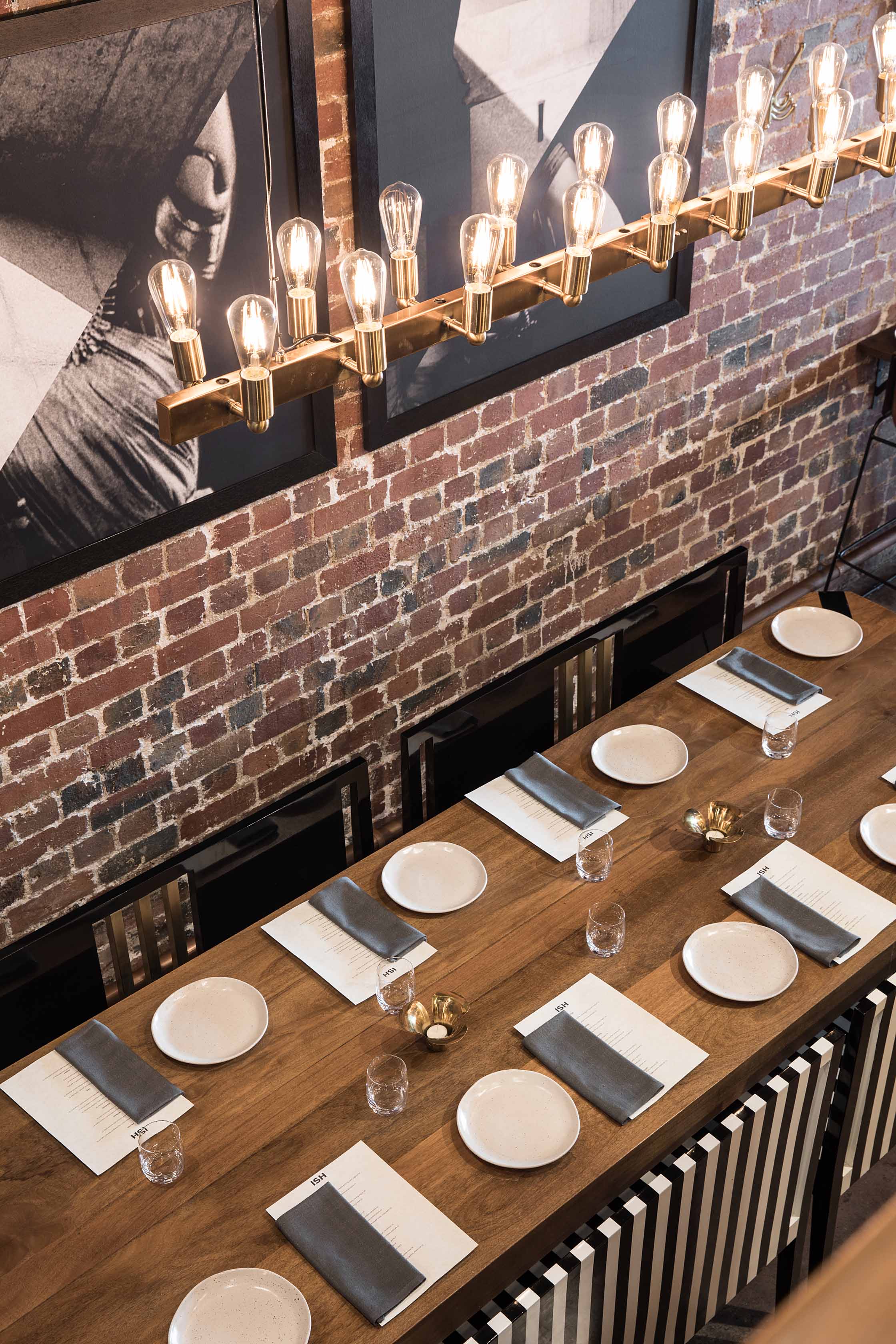 A long communal table and bespoke black and white-striped pews 