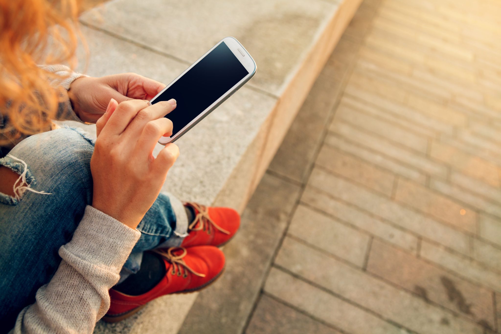 young woman using smart phone at beach