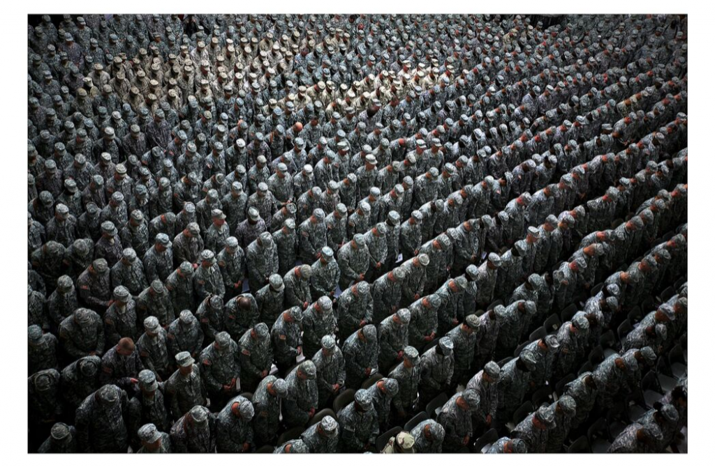 Ashley Gilbertson 1,215 American soldiers, airmen, Marines and sailors pray before a pledge of enlistment on July 4, 2008, at a massive re-enlistment ceremony at one of Saddam Hussein's former palaces in Baghdad, Iraq 2008 from Whiskey Tango Foxtrot series type C photograph 69.0 x 94.0 x 5.5 cm Courtesy of the artist © Ashley Gilbertson / VII Network 