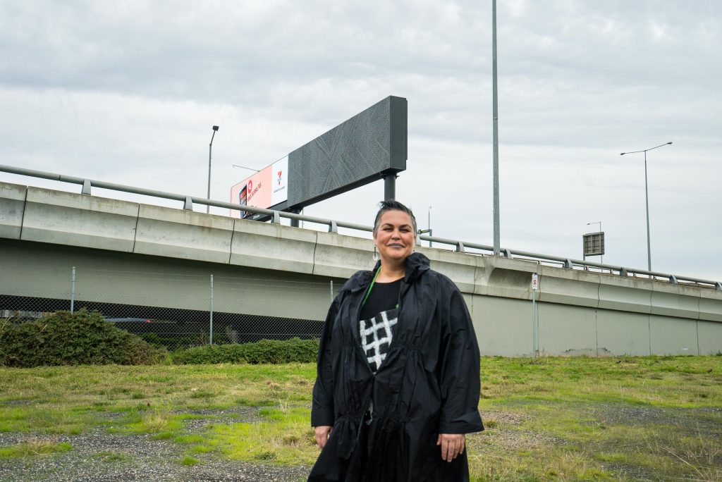 First Peoples artist Lisa Waup next to art installation path between on Melbourne's West Gate Freeway