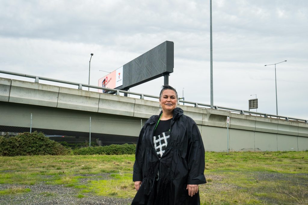 First Peoples artist Lisa Waup next to art installation path between on Melbourne's West Gate Freeway 