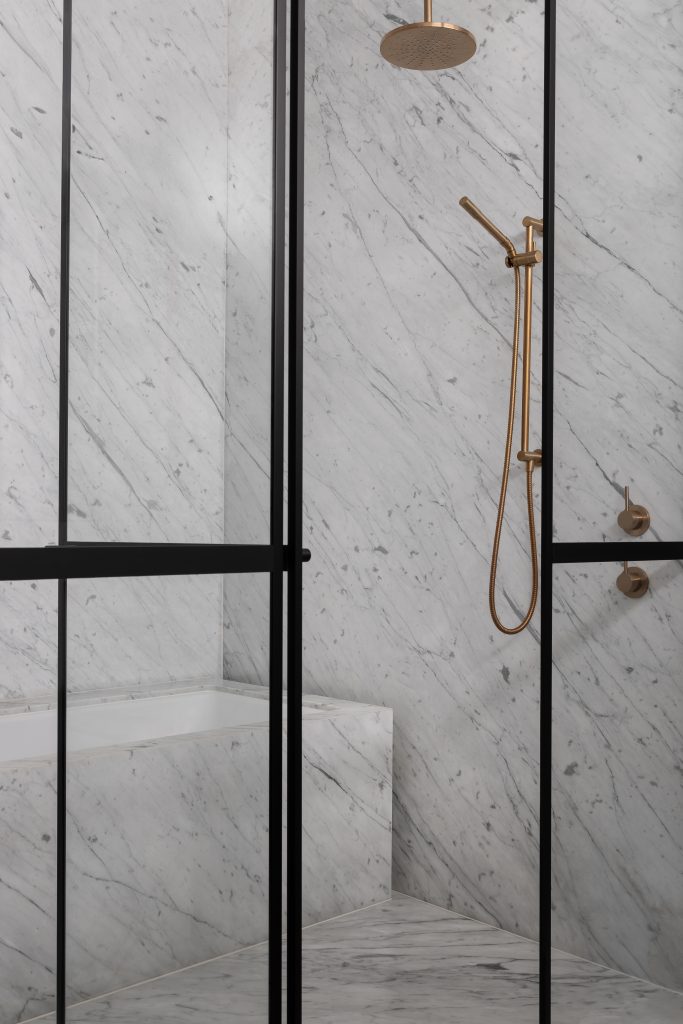 Generous proportions combined with practical in-shower seating crafted from marble transform this shower into a wellness retreat.