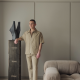 Joss Knight, interior designer, standing in a living room with a neutral earth toned colour palette.
