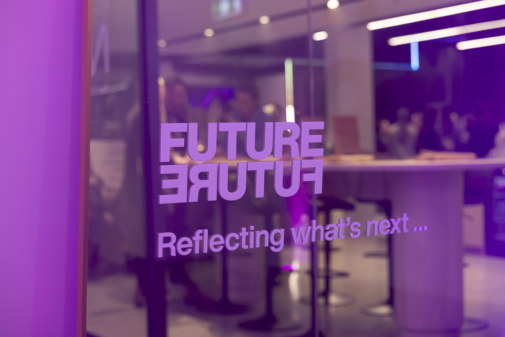 Future Future event indicated by glass door with that title and the tagline Reflecting what's next in purple on it