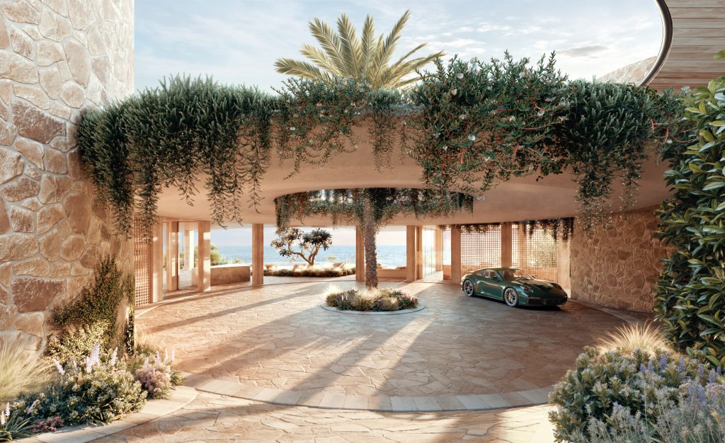 The forecourt of a modern building, circular in shape with a palm tree in the middle and a constructed cover with foliage hanging over. A car is parked to the right. Rob Mills Architects.