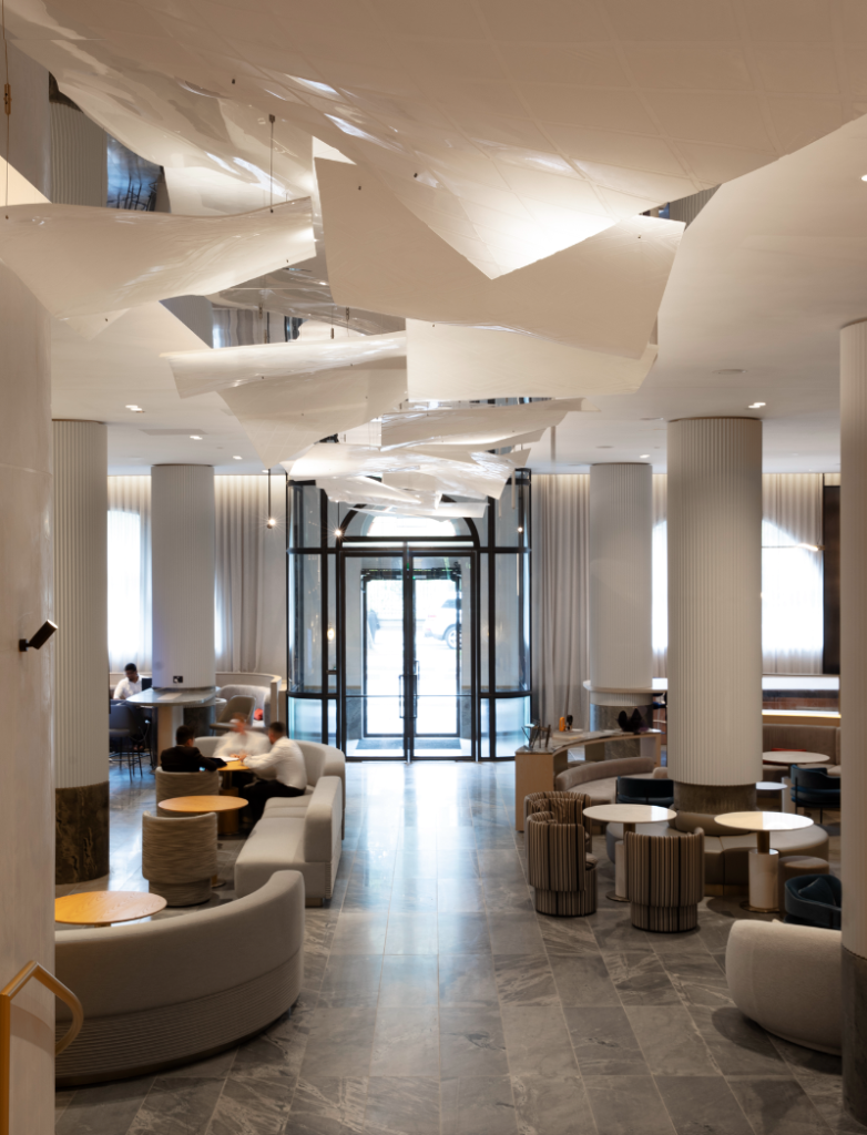 Lanson Place - lobby with curved benches, pillars and the exit doors at the back of the frame